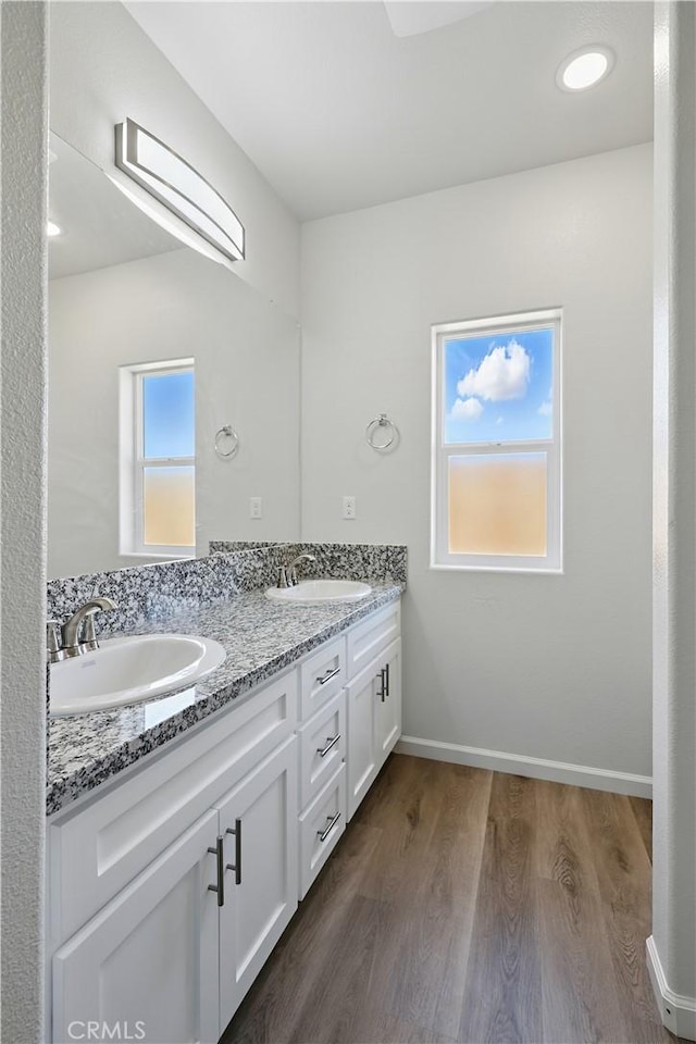428 Oleander Ct, Chowchilla, CA 93610 - bathroom with double vanity, wood finished floors, and baseboards