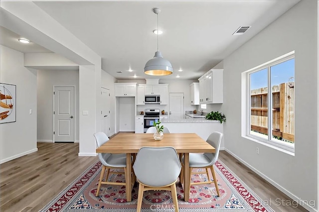 428 Oleander Ct, Chowchilla, CA 93610 - dining room with light wood-type flooring and baseboards