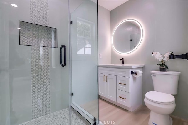2124 Baltic Ave, Long Beach, CA 90810 - bathroom with a stall shower, vanity, toilet, and wood finished floors