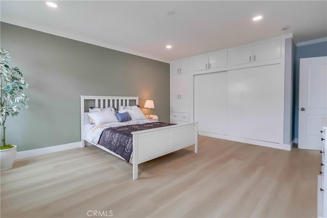 2124 Baltic Ave, Long Beach, CA 90810 - bedroom featuring light wood-style flooring, ornamental molding, recessed lighting, baseboards, and a closet