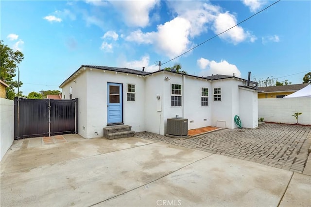 2124 Baltic Ave, Long Beach, CA 90810 - back of property featuring central air condition unit, stucco siding, a patio, and a gate