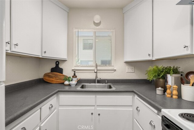 1170 Hobart St, Chico, CA 95926 - kitchen featuring a sink, white cabinets, and dark countertops