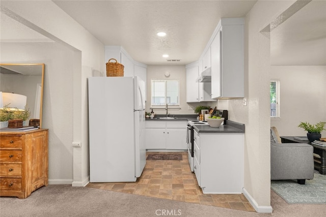 1170 Hobart St, Chico, CA 95926 - kitchen featuring freestanding refrigerator, a sink, dark countertops, white cabinetry, and electric stove