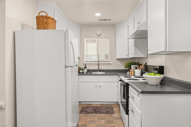 1170 Hobart St, Chico, CA 95926 - kitchen featuring white appliances, under cabinet range hood, a sink, dark countertops, and white cabinetry