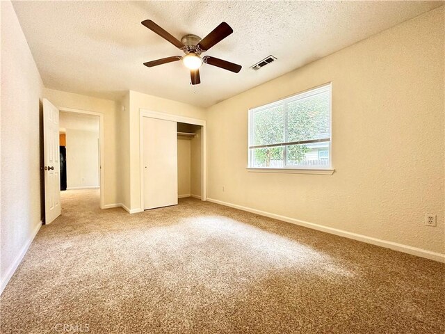 1170 Hobart St, Chico, CA 95926 - unfurnished bedroom with a textured ceiling, carpet, a closet, baseboards, and a textured wall