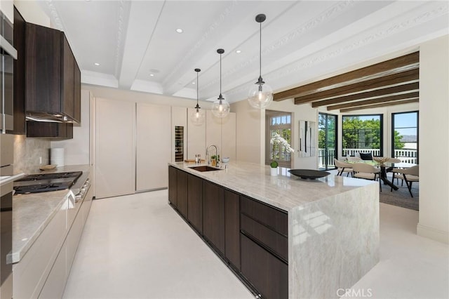 10 Strawberry Ln, San Juan Capistrano, CA 92675 - kitchen featuring dark brown cabinetry, beamed ceiling, recessed lighting, a large island, and modern cabinets