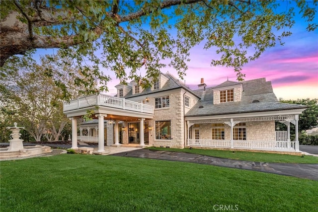 10 Strawberry Ln, San Juan Capistrano, CA 92675 - back of house at dusk with a lawn and stone siding