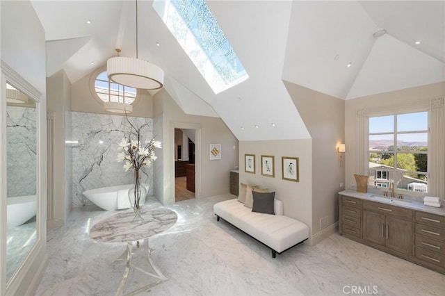 10 Strawberry Ln, San Juan Capistrano, CA 92675 - bedroom with light marble finish floors, high vaulted ceiling, and a skylight
