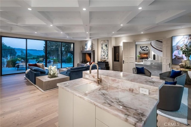 10 Strawberry Ln, San Juan Capistrano, CA 92675 - living area with a lit fireplace, recessed lighting, coffered ceiling, beam ceiling, and light wood-style floors