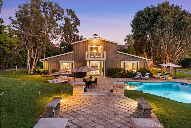 10 Strawberry Ln, San Juan Capistrano, CA 92675 - pool at dusk with a patio, an outdoor pool, and a lawn