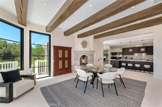 10 Strawberry Ln, San Juan Capistrano, CA 92675 - dining space featuring healthy amount of natural light, recessed lighting, beamed ceiling, and a high end fireplace