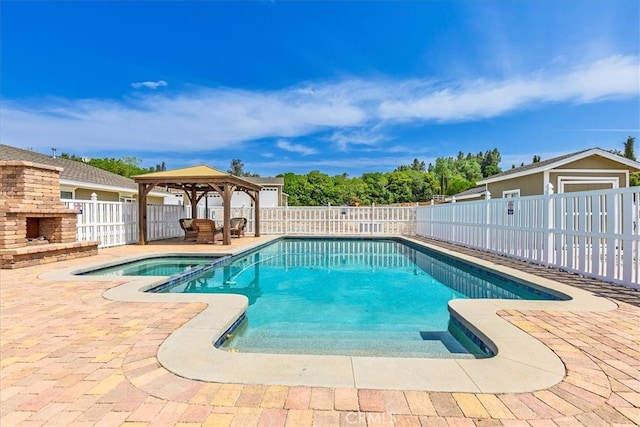 30026 Santiago Rd, Temecula, CA 92592 - view of swimming pool featuring a gazebo, a patio area, a fenced backyard, an outdoor stone fireplace, and a pool with connected hot tub