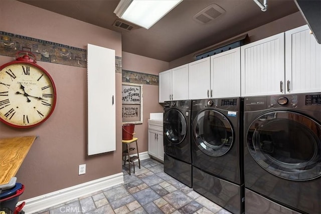 30026 Santiago Rd, Temecula, CA 92592 - laundry room featuring washing machine and dryer, cabinet space, and stone finish floors