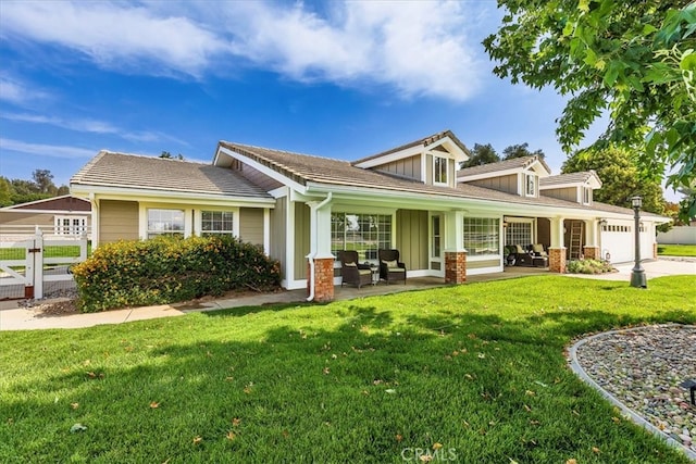 30026 Santiago Rd, Temecula, CA 92592 - view of front of property with board and batten siding, an attached garage, an outdoor hangout area, and driveway