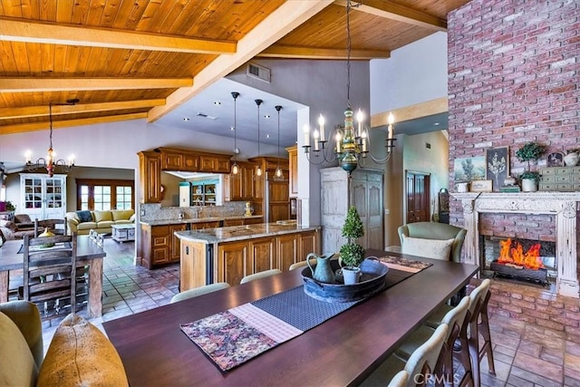 30026 Santiago Rd, Temecula, CA 92592 - dining space with a chandelier, a wood ceiling with exposed beams, a fireplace, and high vaulted ceiling