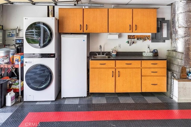 30026 Santiago Rd, Temecula, CA 92592 - laundry room featuring stacked washer / dryer, electric panel, and a garage