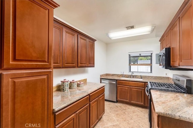 30026 Santiago Rd, Temecula, CA 92592 - kitchen featuring stainless steel appliances, light stone countertops, light tile patterned floors, and brown cabinetry