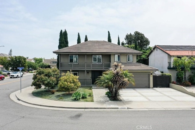 21822 Seacrest Ln, Huntington Beach, CA 92646 - view of front of home with stucco siding, driveway, a garage, and a balcony