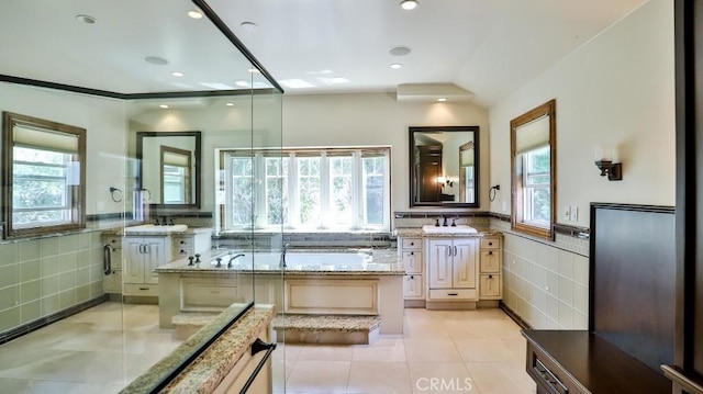 21822 Seacrest Ln, Huntington Beach, CA 92646 - bathroom featuring tile walls, tile patterned floors, a garden tub, vanity, and a wainscoted wall
