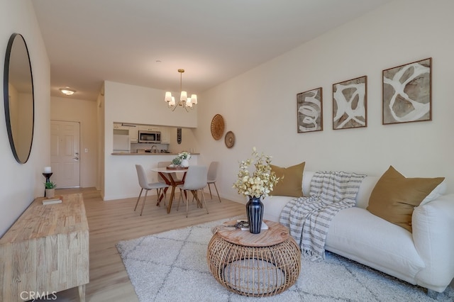 3120 Sepulveda Blvd Unit 312, Torrance, CA 90505 - living area featuring a chandelier, wood finished floors, and baseboards