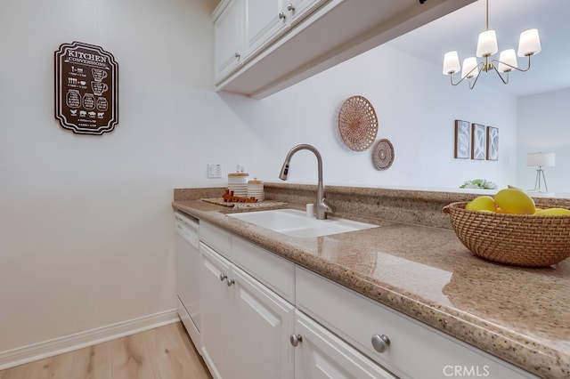 3120 Sepulveda Blvd Unit 312, Torrance, CA 90505 - kitchen with a sink, white dishwasher, white cabinets, and light stone countertops