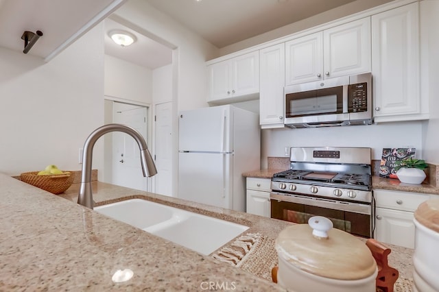 3120 Sepulveda Blvd Unit 312, Torrance, CA 90505 - kitchen featuring stainless steel appliances, a sink, white cabinetry, and light stone counters