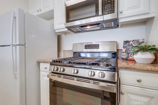 3120 Sepulveda Blvd Unit 312, Torrance, CA 90505 - kitchen featuring stainless steel appliances, white cabinets, and light stone countertops