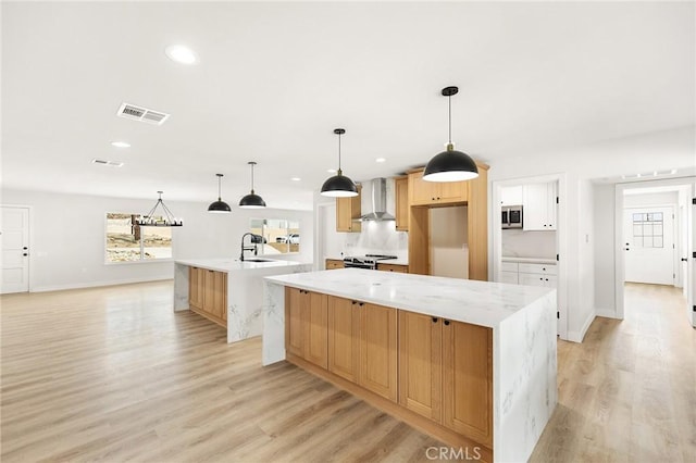 27130 Blue Hill Dr, Menifee, CA 92586 - kitchen featuring wall chimney range hood, a large island, stainless steel appliances, light wood-style flooring, and recessed lighting