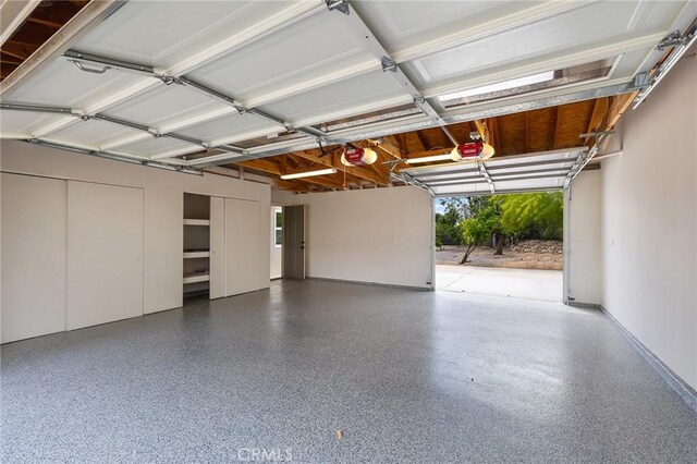 27130 Blue Hill Dr, Menifee, CA 92586 - garage featuring a garage door opener and baseboards