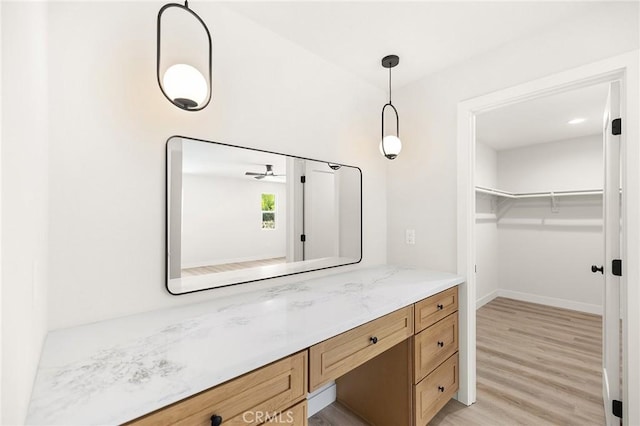 27130 Blue Hill Dr, Menifee, CA 92586 - bathroom featuring wood finished floors, vanity, baseboards, and a spacious closet