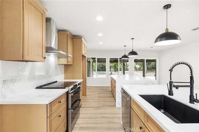27130 Blue Hill Dr, Menifee, CA 92586 - kitchen with wall chimney exhaust hood, appliances with stainless steel finishes, a sink, light wood-style flooring, and recessed lighting