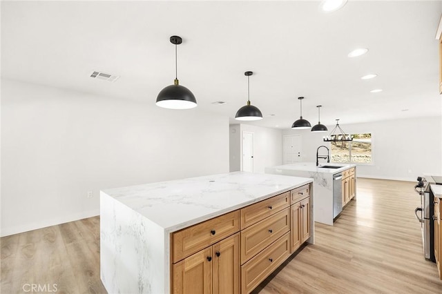 27130 Blue Hill Dr, Menifee, CA 92586 - kitchen featuring an island with sink, a sink, light wood finished floors, recessed lighting, and appliances with stainless steel finishes