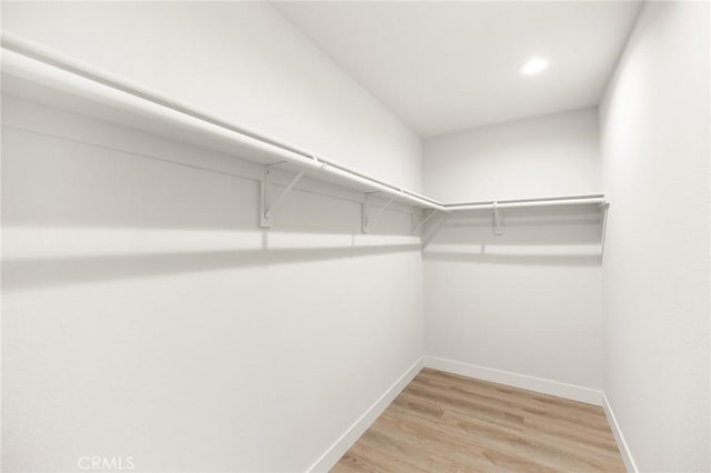 27130 Blue Hill Dr, Menifee, CA 92586 - walk in closet with light wood-style flooring
