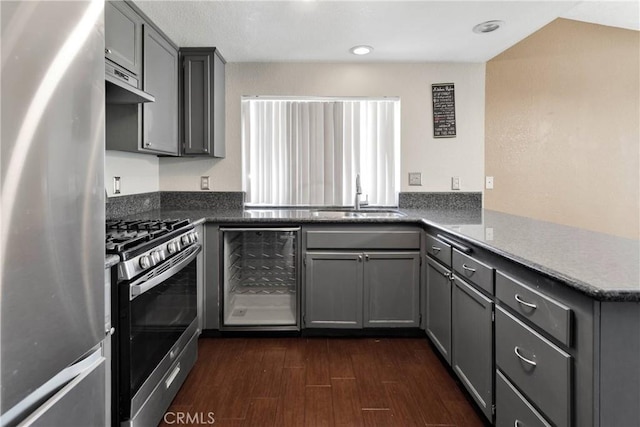 11941 9th Ave, Hesperia, CA 92345 - kitchen featuring appliances with stainless steel finishes, wine cooler, a sink, gray cabinets, and a peninsula