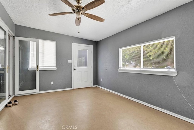 11941 9th Ave, Hesperia, CA 92345 - entrance foyer with a ceiling fan, finished concrete floors, a textured ceiling, baseboards, and a textured wall