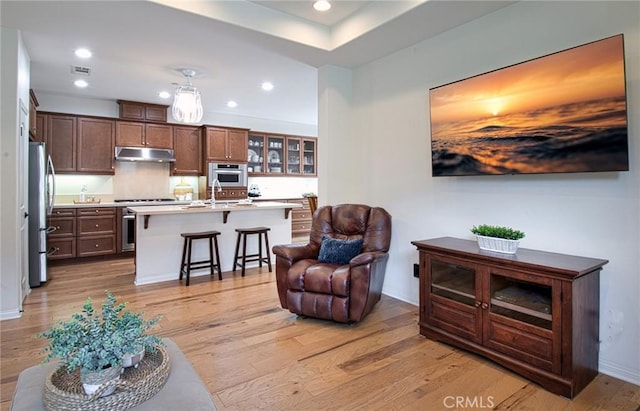 67 Galan St, Rancho Mission Viejo, CA 92694 - living room featuring light wood-style flooring, baseboards, and recessed lighting