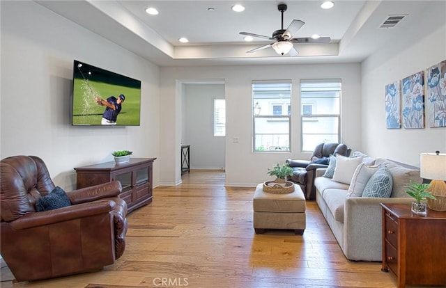 67 Galan St, Rancho Mission Viejo, CA 92694 - living room featuring a raised ceiling, light wood-type flooring, a ceiling fan, recessed lighting, and baseboards