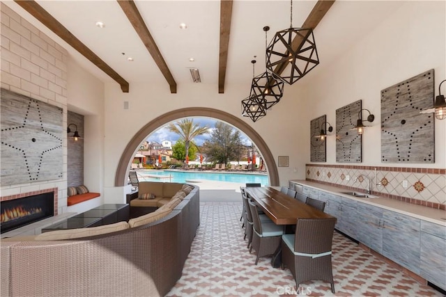 67 Galan St, Rancho Mission Viejo, CA 92694 - view of patio / terrace with an outdoor living space with a fireplace, a sink, and a community pool