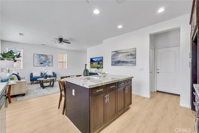 719 Huron Pl, Claremont, CA 91711 - kitchen featuring light wood-style flooring, ceiling fan, a kitchen island, dark brown cabinetry, and recessed lighting