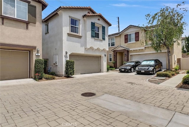 719 Huron Pl, Claremont, CA 91711 - view of front facade with stucco siding, an attached garage, decorative driveway, and a tile roof