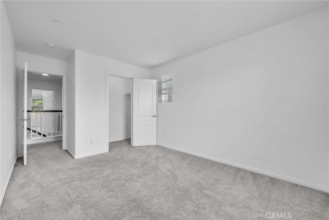 719 Huron Pl, Claremont, CA 91711 - unfurnished bedroom featuring carpet floors, multiple windows, and a closet