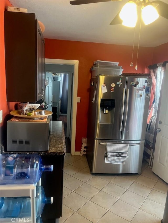 2118 E Bliss St, Compton, CA 90222 - kitchen with stainless steel fridge with ice dispenser, a ceiling fan, light tile patterned flooring, and dark stone countertops