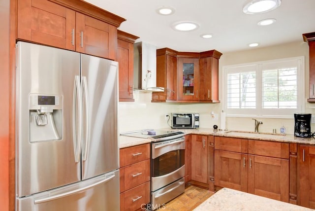 2092 Ronda Granada Unit C, Laguna Woods, CA 92637 - kitchen with stainless steel appliances, a sink, wall chimney exhaust hood, brown cabinets, and recessed lighting