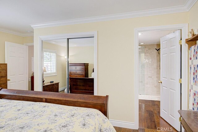 2092 Ronda Granada Unit C, Laguna Woods, CA 92637 - bedroom with wood finished floors, crown molding, a closet, baseboards, and ensuite bath