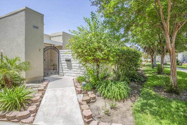 2092 Ronda Granada Unit C, Laguna Woods, CA 92637 - property entrance featuring stucco siding and a gate