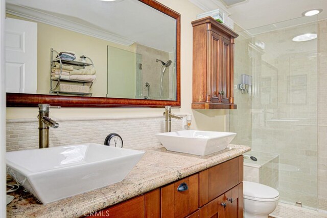 2092 Ronda Granada Unit C, Laguna Woods, CA 92637 - full bath featuring a stall shower, ornamental molding, toilet, and double vanity