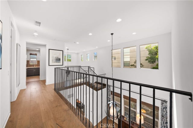 105 Newall, Irvine, CA 92618 - corridor featuring recessed lighting, an upstairs landing, wood finished floors, a sink, and baseboards