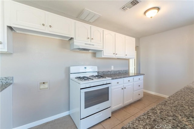 11314 Mariposa Rd, Hesperia, CA 92345 - kitchen featuring white range with gas cooktop, under cabinet range hood, dark stone counters, and white cabinets