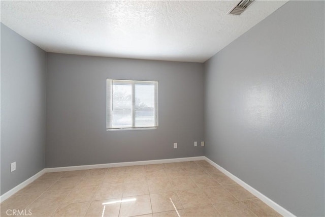 11314 Mariposa Rd, Hesperia, CA 92345 - empty room featuring a textured ceiling, light tile patterned floors, and baseboards
