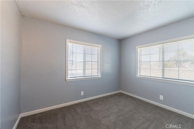 11314 Mariposa Rd, Hesperia, CA 92345 - spare room with dark carpet and baseboards
